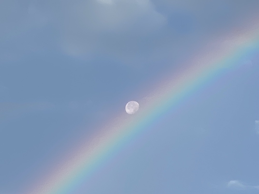 Moon riding rainbow